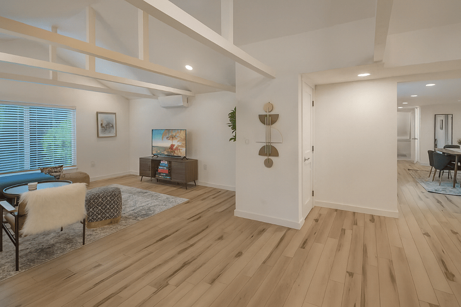 Spacious open floor plan with warm wood flooring, high ceilings, and stylish modern finishesdesigned for comfort and flow throughout your stay.
