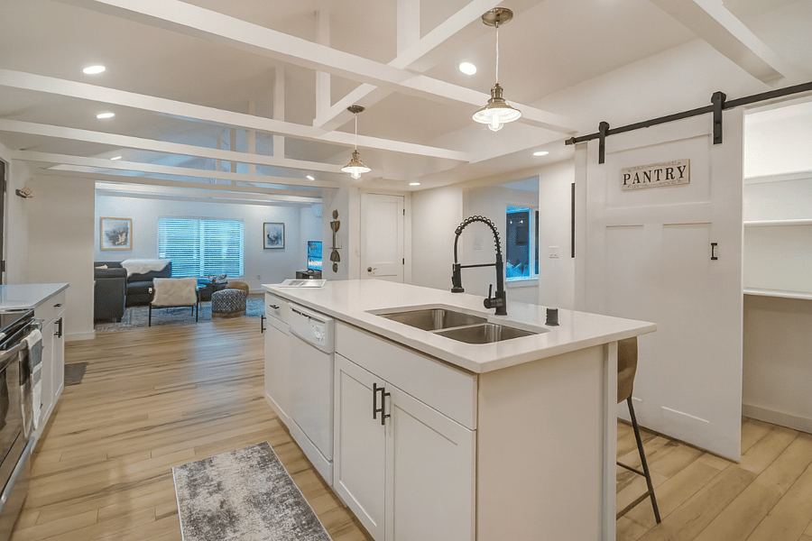 Spacious open-concept kitchen with a large island, sleek finishes, and direct flow into the cozy living roomperfect for entertaining or relaxed nights in