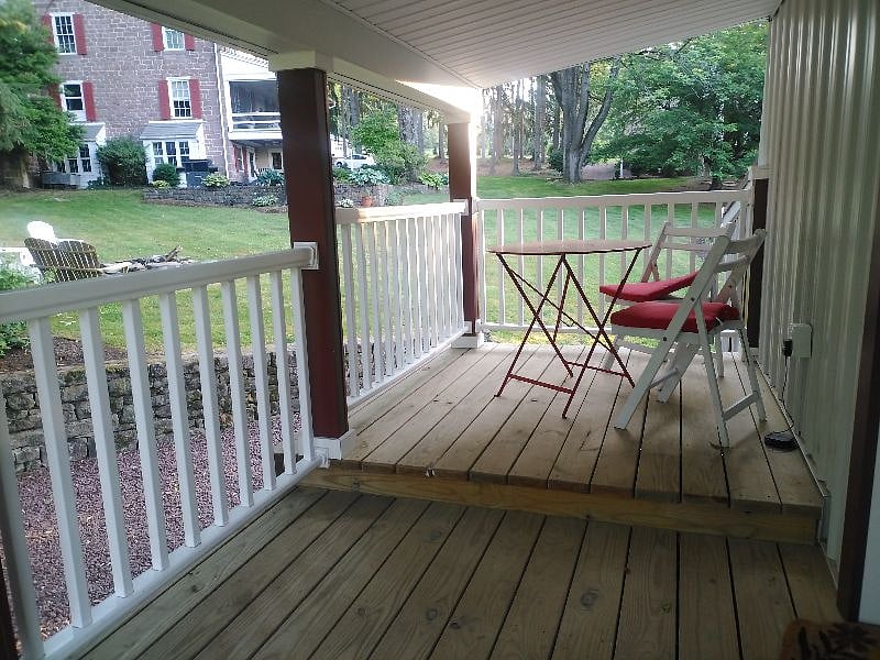 Front porch with seating and table. Here you can see the distance from our home so there is plenty of privacy