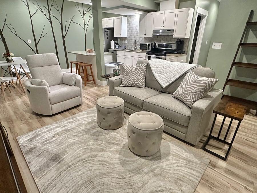 Living room features lots of comfy seating options, including a swivel recliner!
