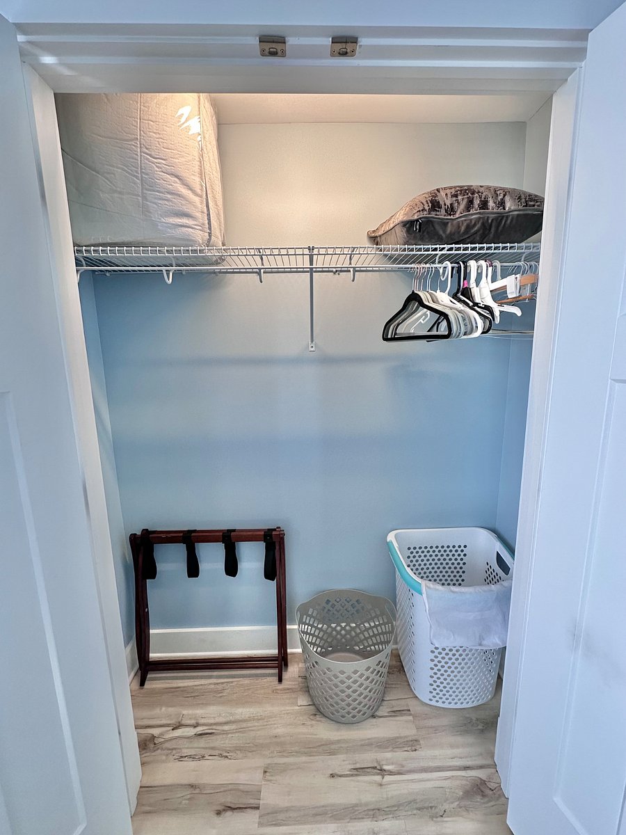 The bedroom closet is one of 3 large closets in the apartment. It's furnished with a luggage rack, clothes hampers, and hangers for your convenience.