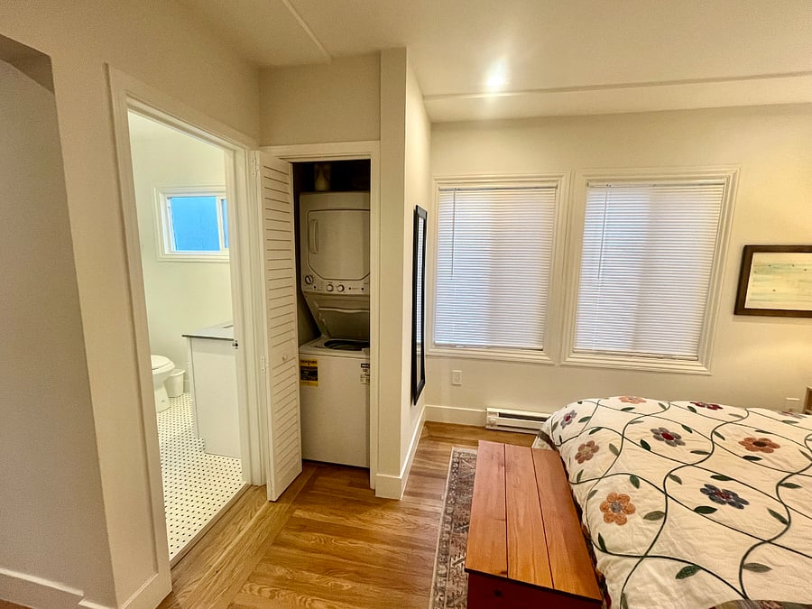 washer/dryer unit in bedroom, adjacent to bathroom 