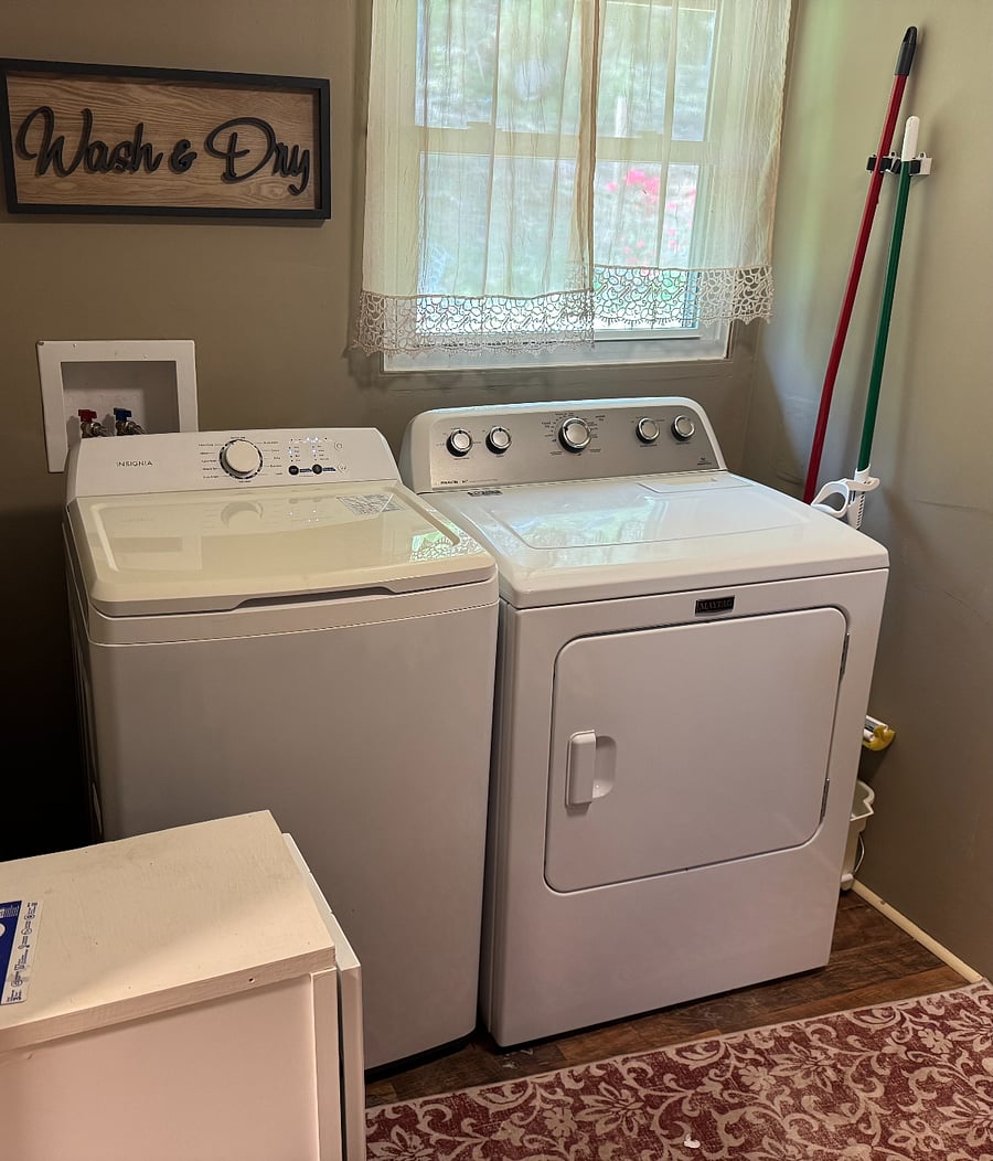 Full washer and dryer with clothes baskets.