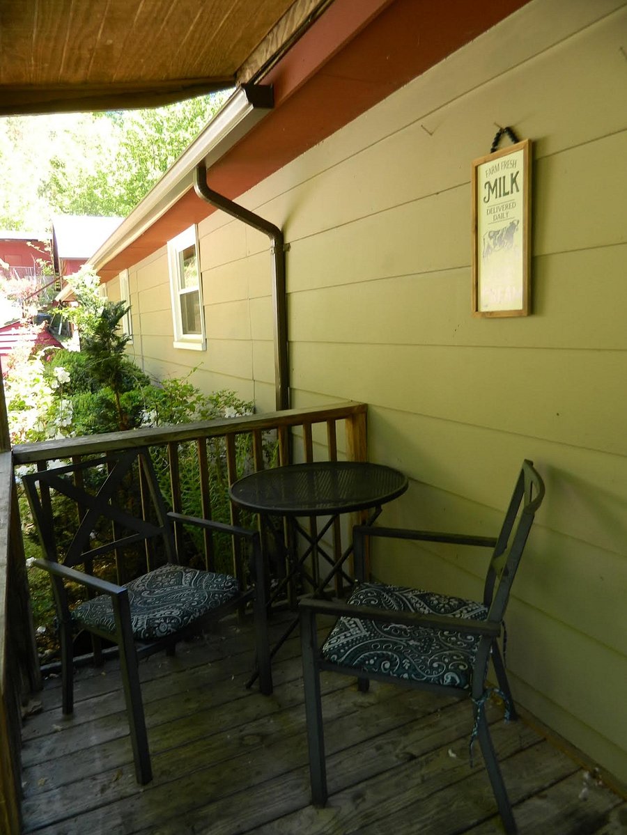 The back porch sits 2. Has a gas grill. This porch overlooks the back yard and patio table and firepit.