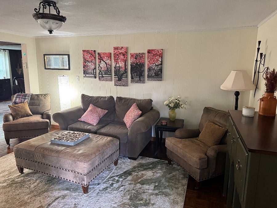 Sitting room has a work desk and a 65 TV