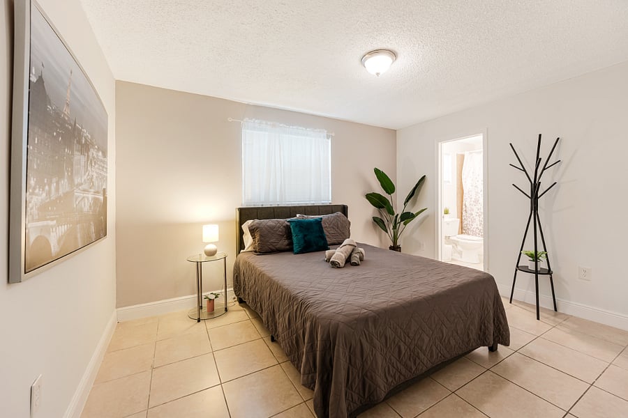 Spacious master bedroom with a queen bed and tasteful furnishings, offering a peaceful retreat with an ensuite bathroom.
