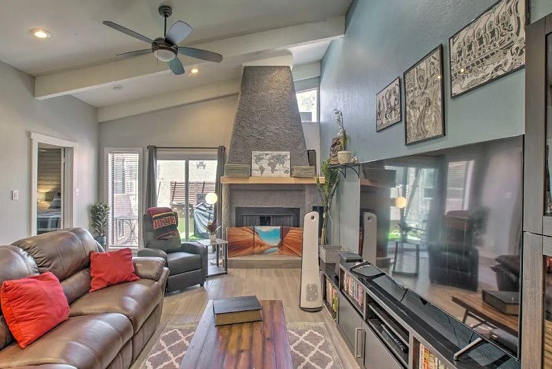 Outside blue sliding glass door is small table and chairs with BBQ and smoker.