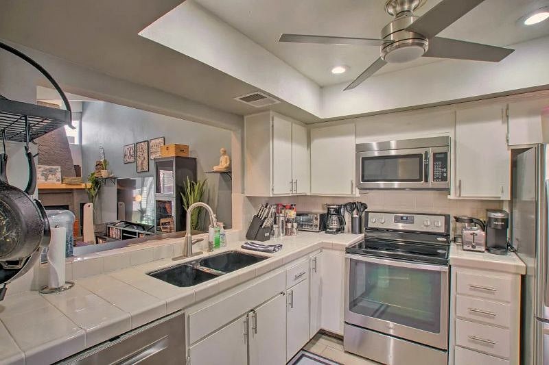 Kitchen with ceiling fan and all updated stainless steel appliances.