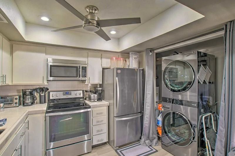 Kitchen with large capacity LG stackable washer dryer. Small pantry with spices available to use.