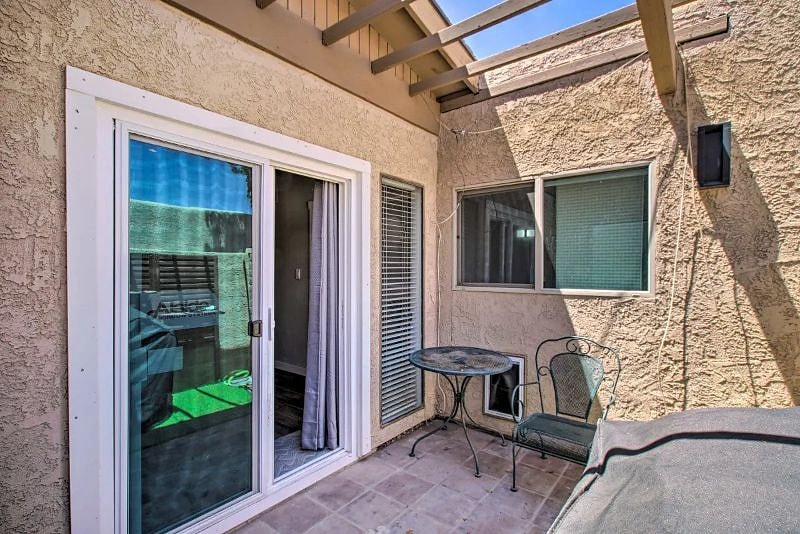 Back Patio with small table 2 chairs. Gas BBQ and Electric smoker.