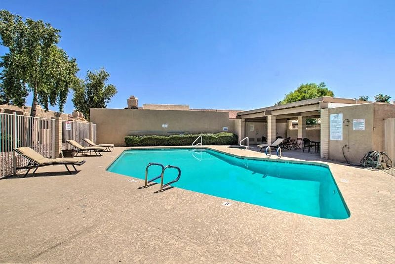 Large community pool, hot tub, lounging chairs, tables and chairs