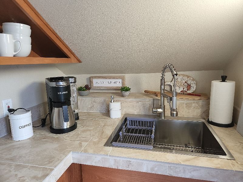 Sink, coffee and prep station with additional storage below.