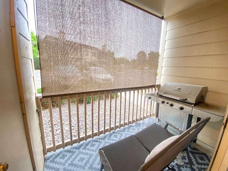 balcony set up with seating, BBQ grill & privacy screen