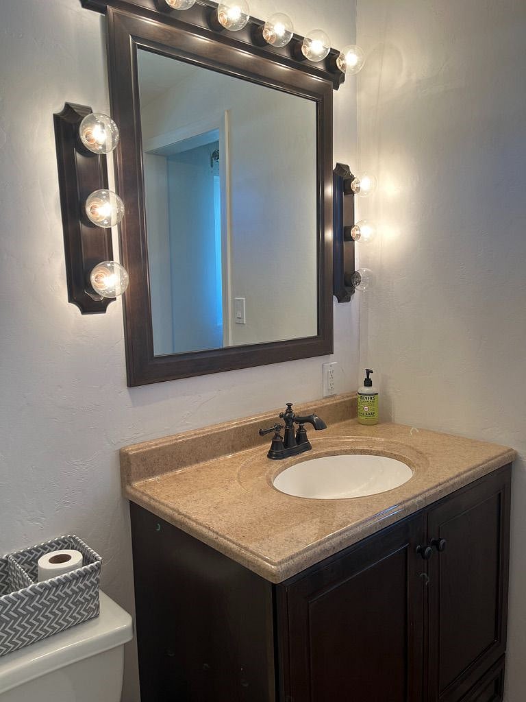 Your in-room full bath has bright lighting and lots of space to store your things.