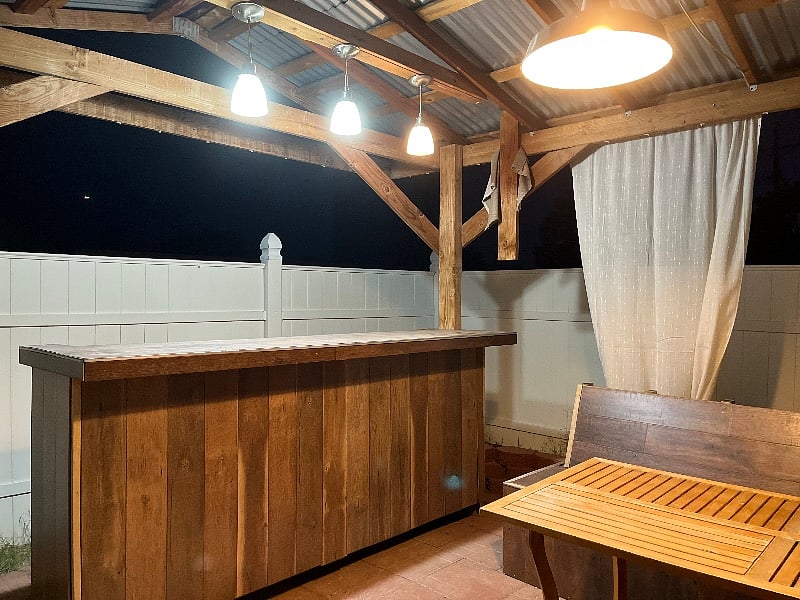 View of bar from inside pergola. 