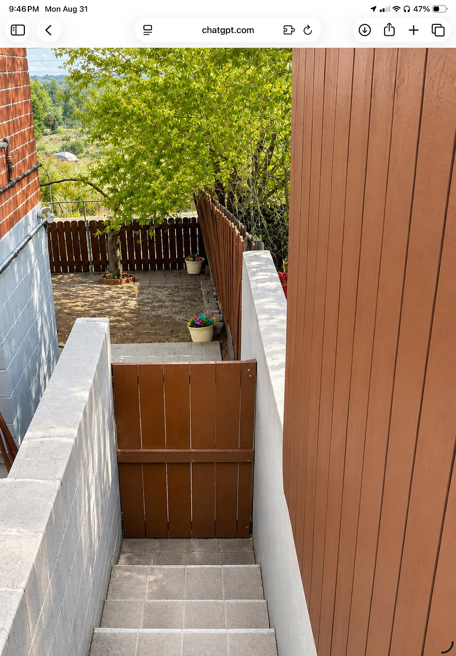 To the right of the garage are stairs and a gate leading to the backyard and the sliding glass door private entrance.