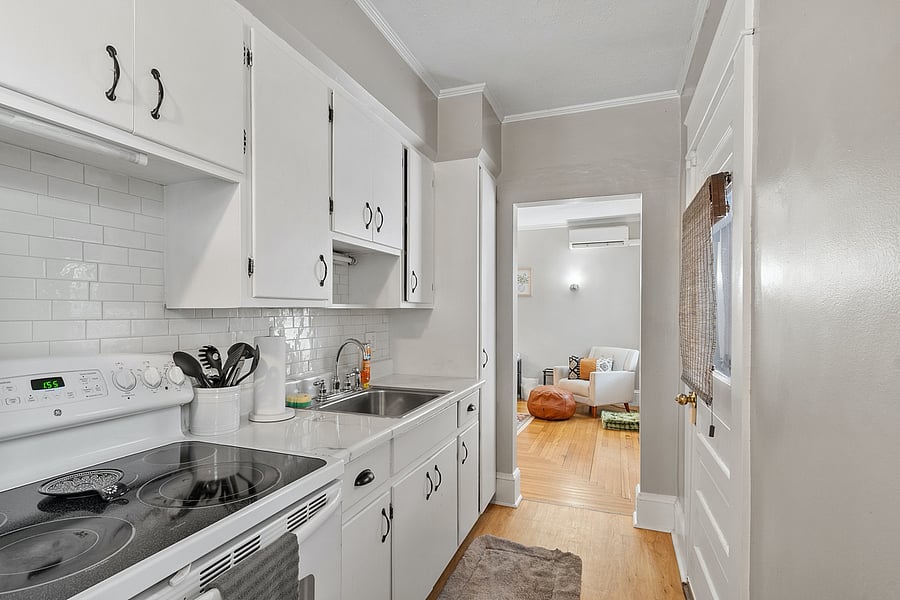 Enjoy this bright kitchen featuring all essentialscoffee, microwave, blender, utensilsand a bar-top eating area with stunning floor-to-ceiling window views. Perfect for meals, coffee breaks, or casual dining.