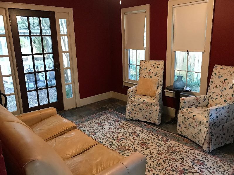 Back of the apartment sunroom opens to fenced in backyard