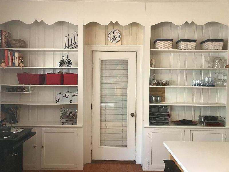 Lots of storage for groceries and suppliers on shelving and under cabinets (original to historic home)