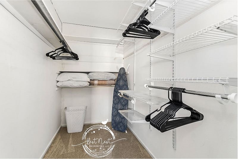 Spacious walk in closet with plenty of storage space.   