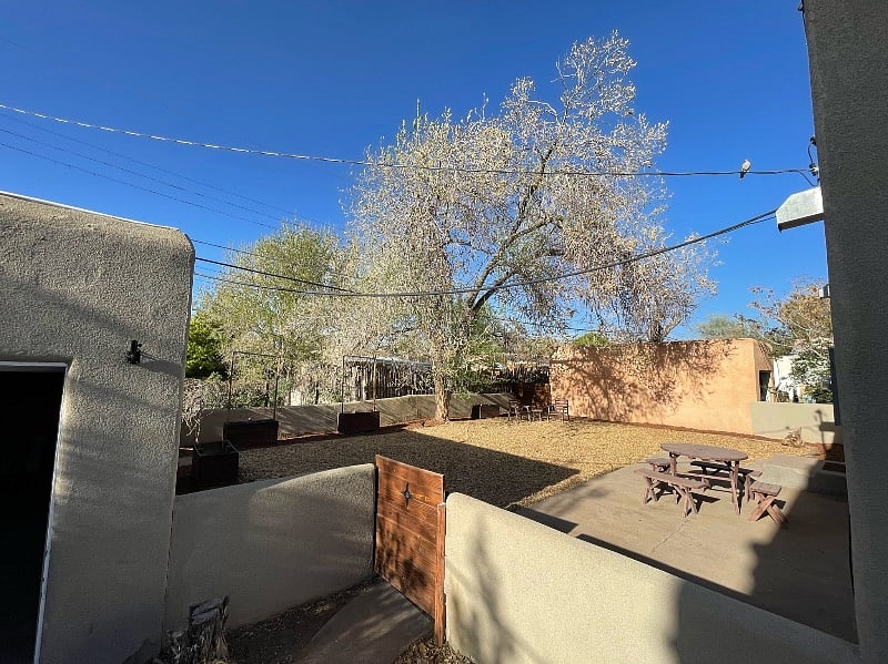 Looking into back yard and garage from end of driveway