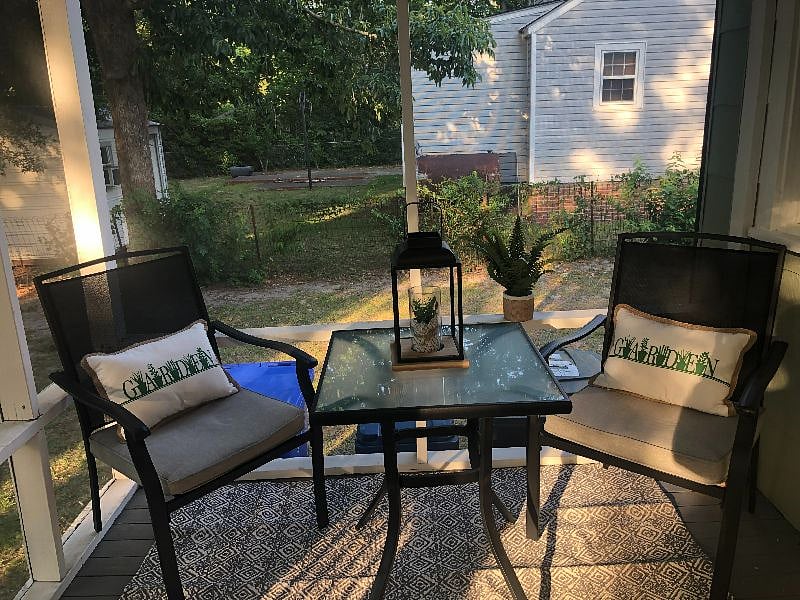Screened porch with table and chairs for relaxing and listening to the birds and squirrels.