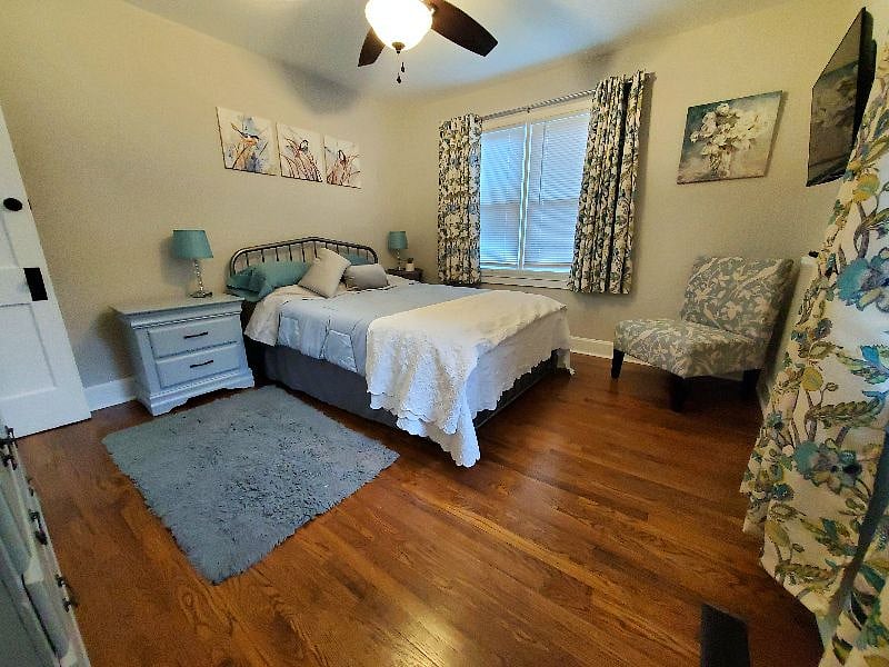 Bedroom 1 with queen bed, closet, TV and dresser