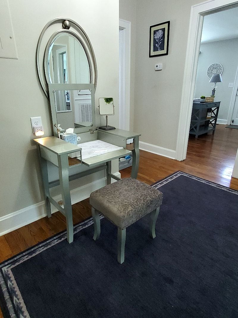 Hallway that has a vanity table for hair/make-up prep