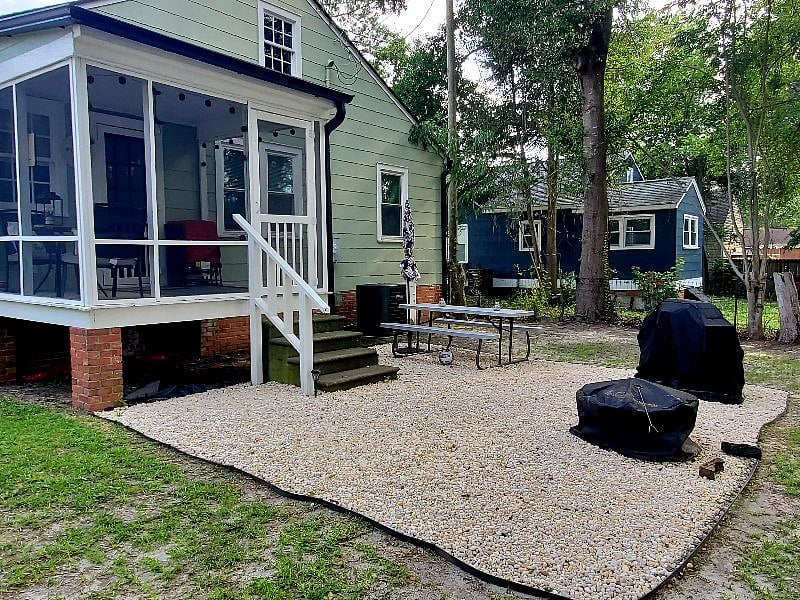 Back yard with screened in porch/ BBQ, picnic table & firepit.