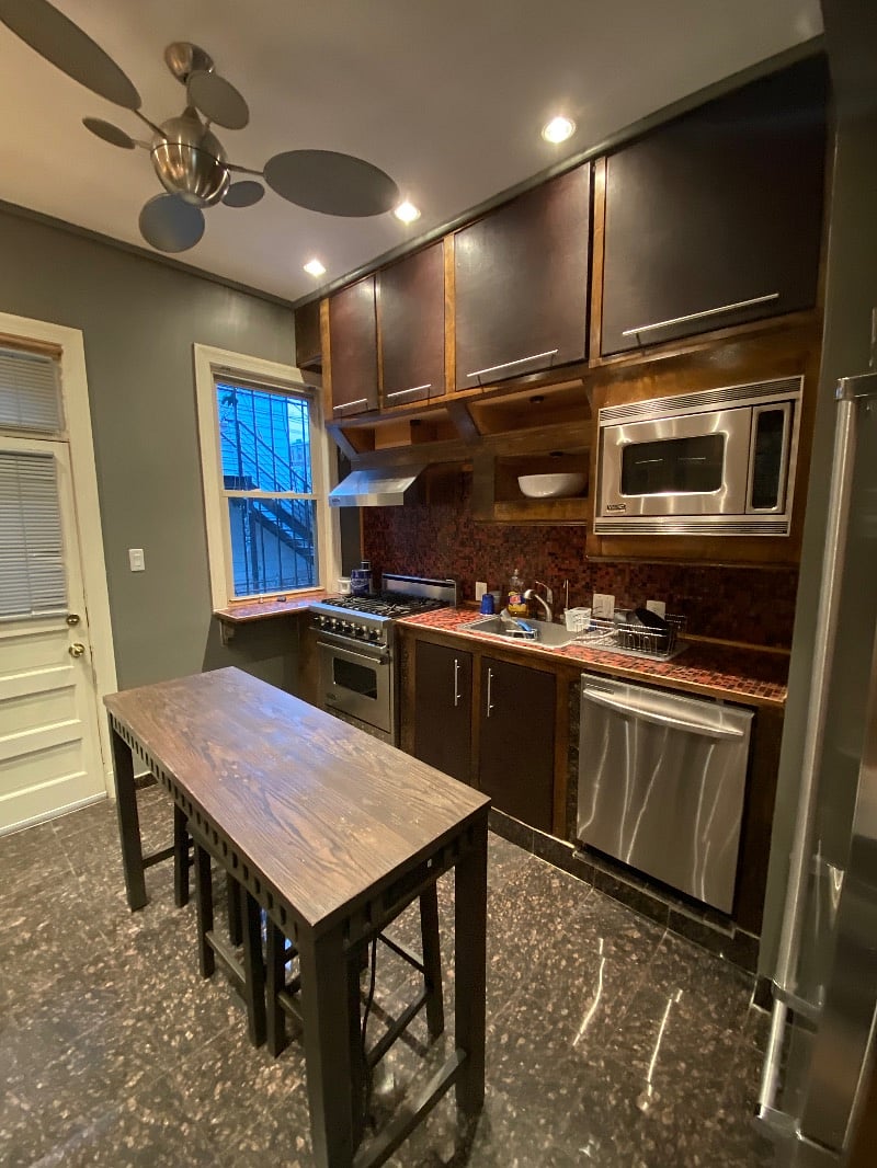Kitchen (shared). Granite stone floors accented with Bisazza title, Viking appliances, and access to rear patio.