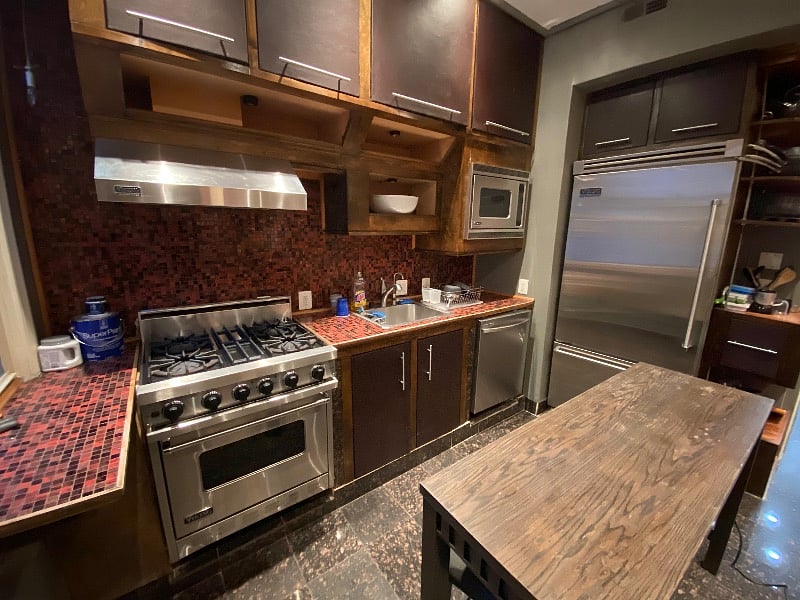 Kitchen (shared). Granite stone floors accented with Bisazza title, Viking appliances, and access to rear patio.