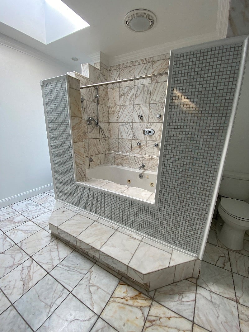 Spa bath (shared). Marble stone accented with Bisazza title, jacuzzi tub, shower jets, and access to a sky deck. 