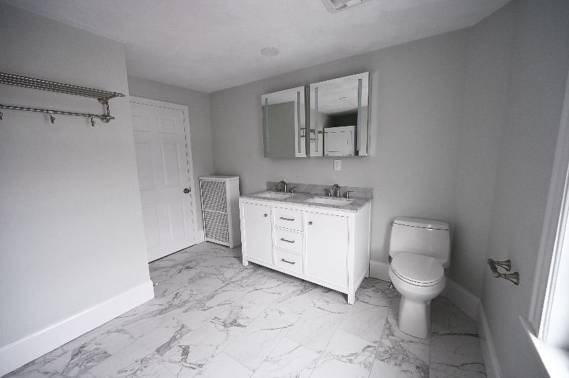 Your oversize bathroom has a double vanity, a full tub and exclusive laundry.