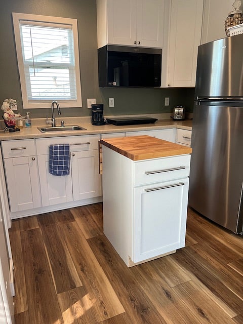 This cabinet base is on wheels so you can move it next to give more counter space while preparing meals, and then roll back next to refrigerator when not needed.