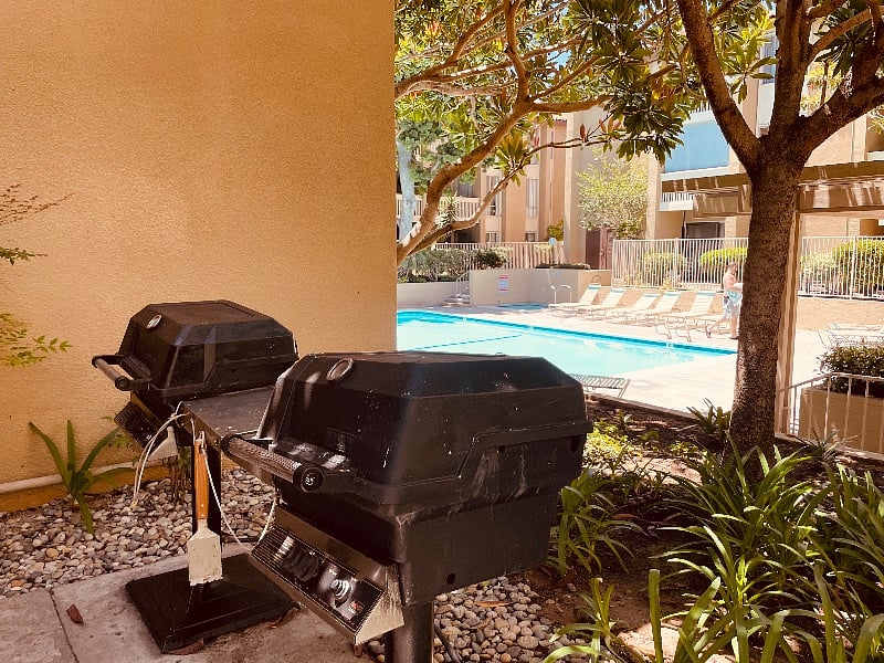 BBQs in pool/jacuzzi area across from the unit.
