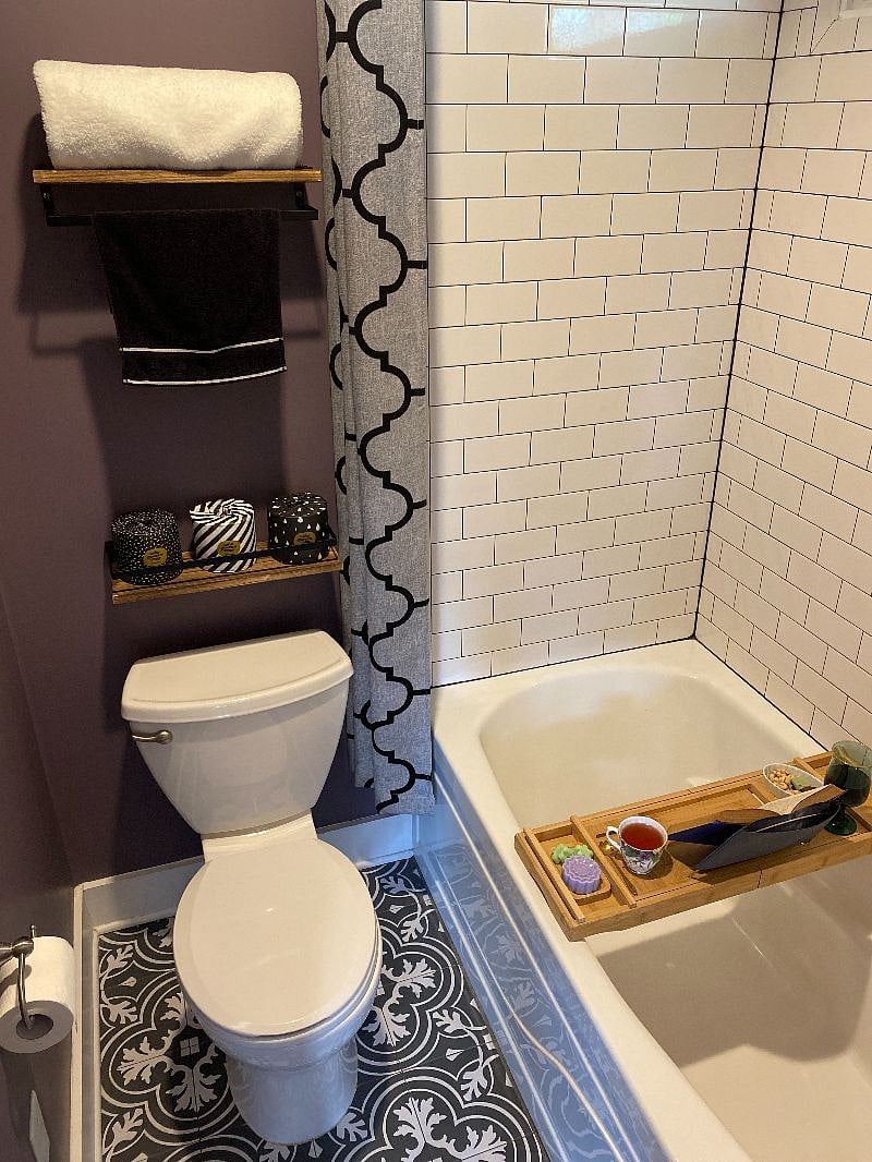 Tiled bathroom with shower bath combo, supplied with towels & starter supplies. 