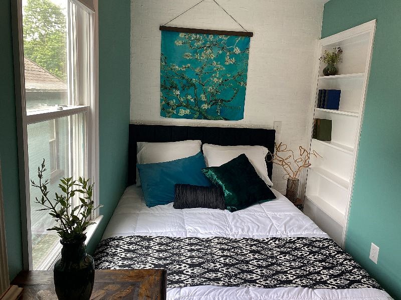 Your beautiful bedroom with queen size bed, natural light, blackout blinds, bookshelf & cozy comfort.