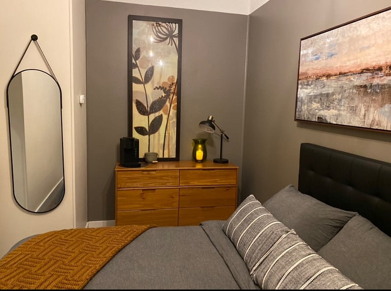 Bedroom with blackout curtains and roller shade, white noise machine, earplugs and full length mirror. Bedside lamp has a charge port to charge your cell phone. Battery operated candles.