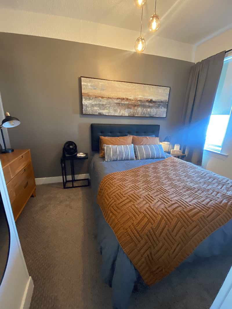 Fan, ear plugs and sound machine provided. Lamp on nightstand has a charger outlet. 'C' table next to bed for your laptop.