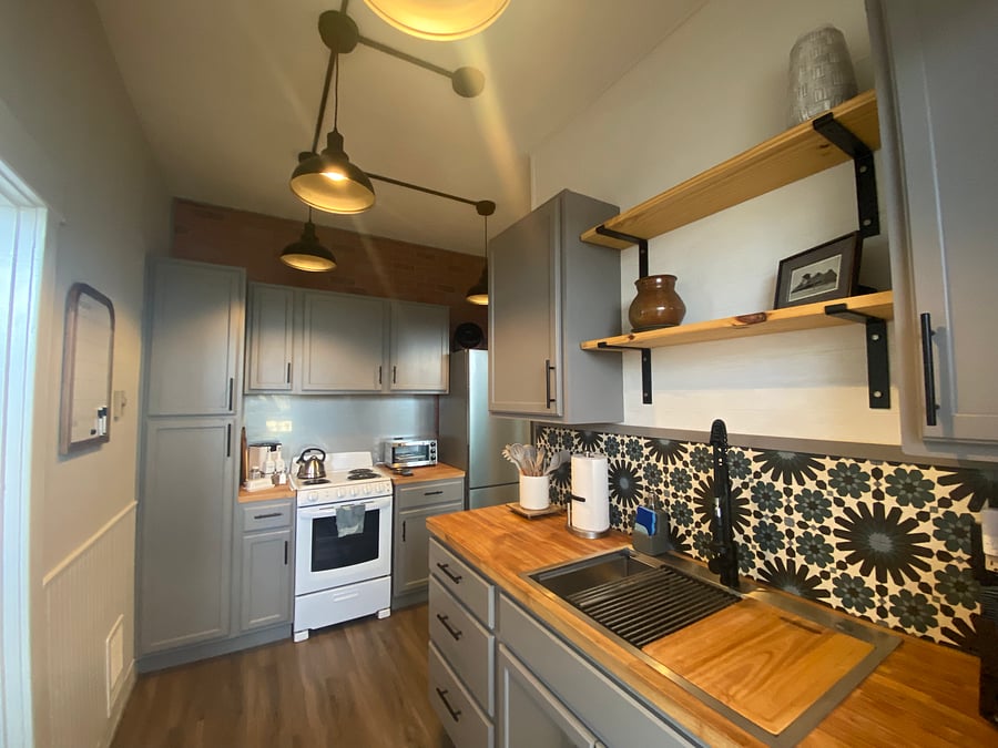 Apartment sized stove. Tall skinny full-sized fridge. 