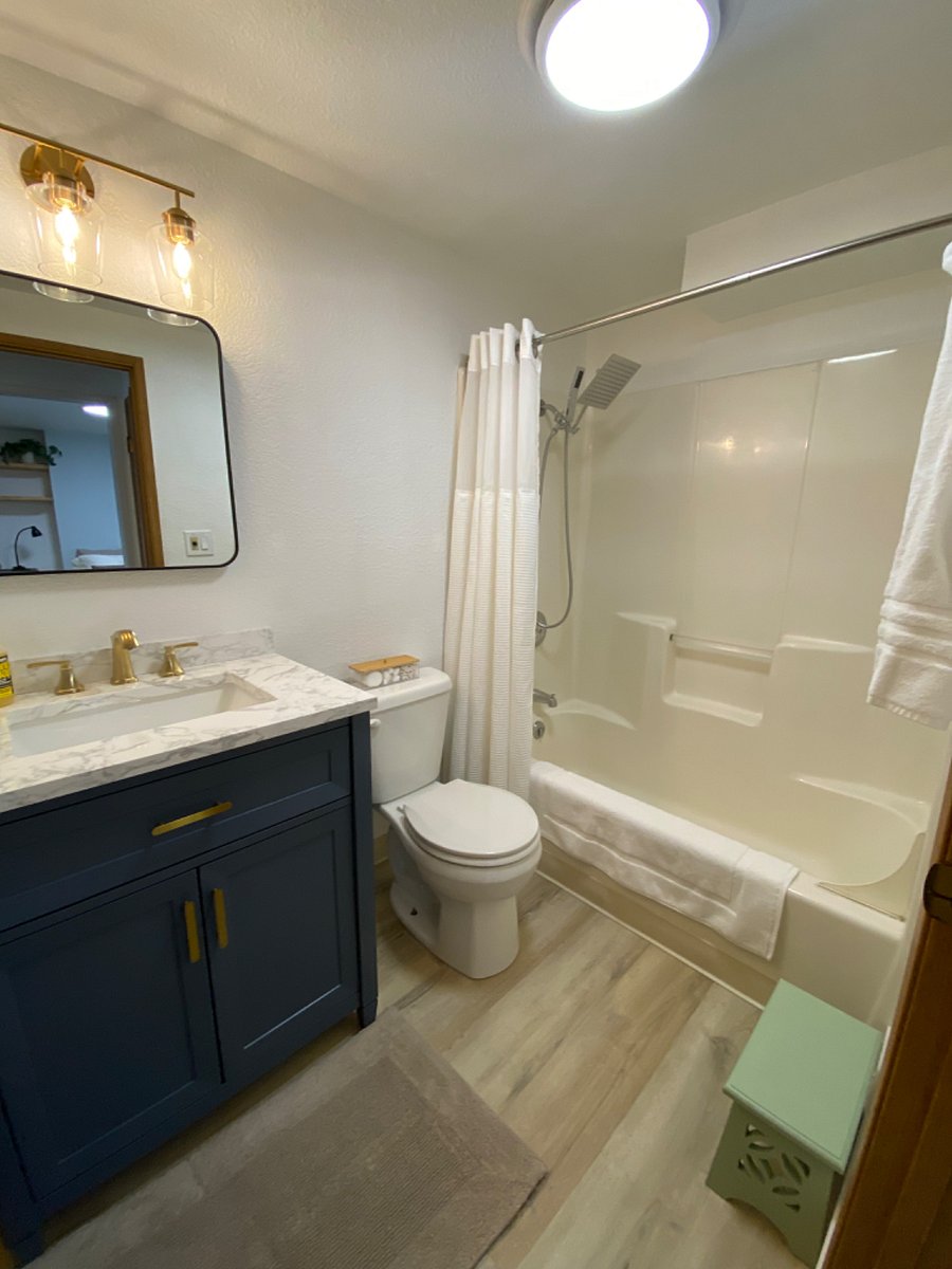 Bathroom with tub and rain shower.