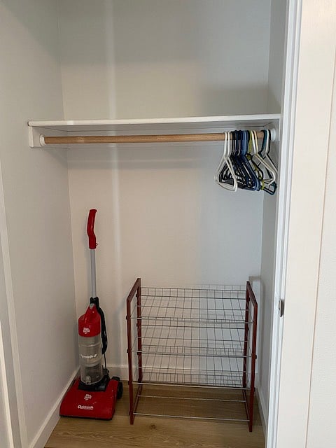 Large bedroom closet with shelf.