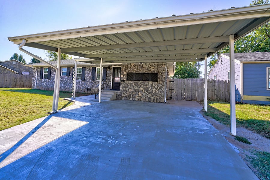 Large concrete driveway with covered carport
