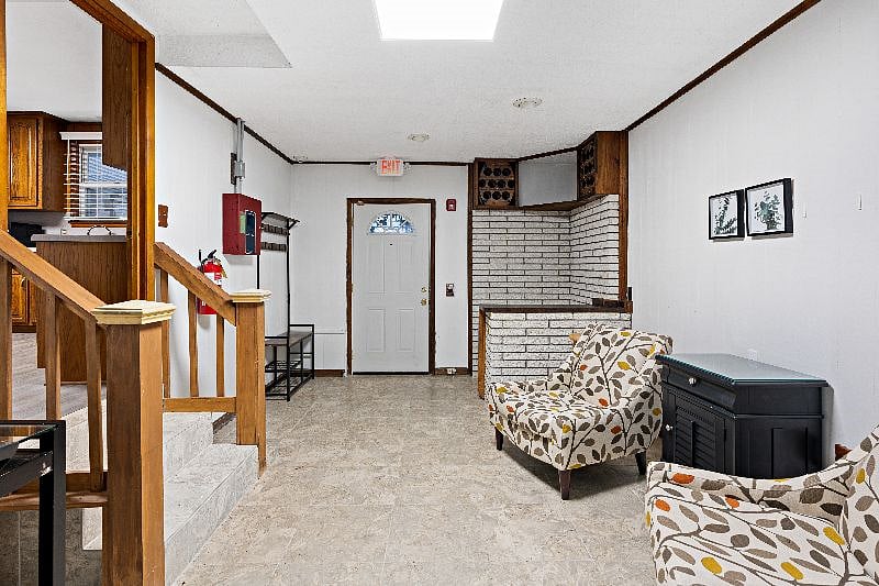Living room 3 with back door out to covered parking carport and stairs into Kitchen
