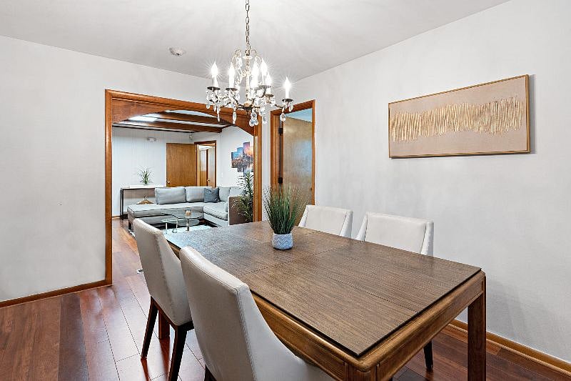 Dining room with door into bedroom 1 and looking into living room 2