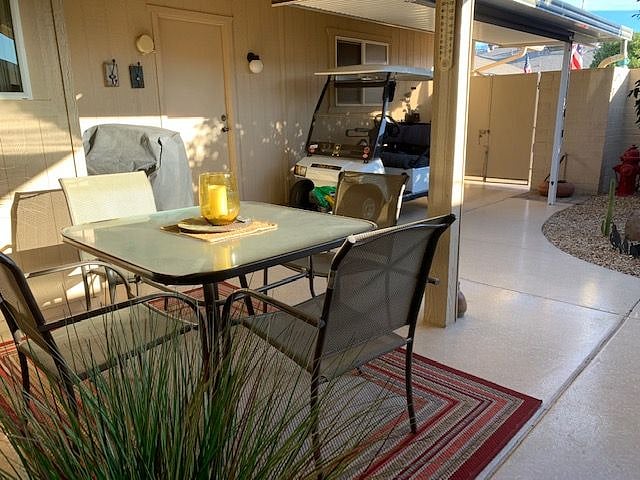Outdoor seating for 4 at the table with 2 additional chairs near the outdoor firepit