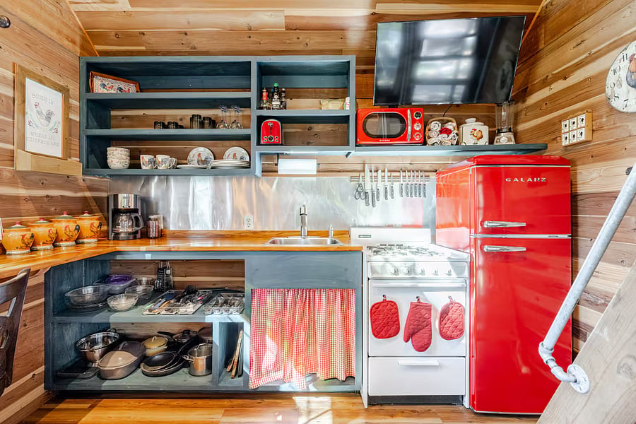 The kitchen is equiped with a stove/oven, refrigerator, microwave, coffee maker, plates, glassware, utensils and cookware.