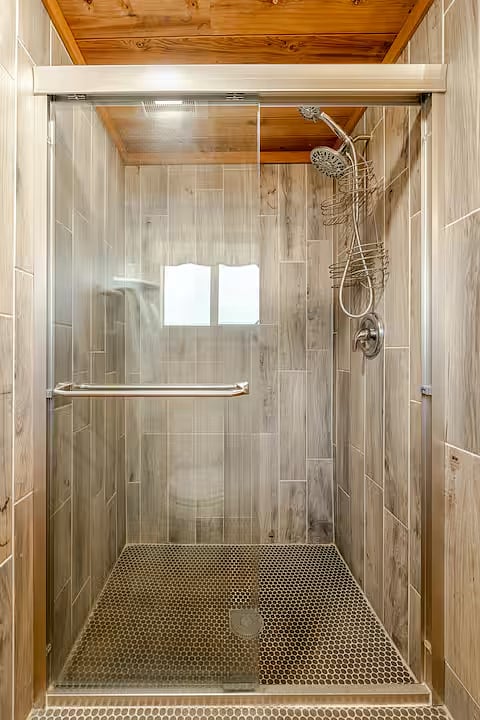 The bathroom has a spacious shower.