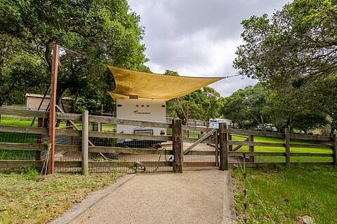 Follow the decomposed granite path through the gate to the Trailer in the Oaks.