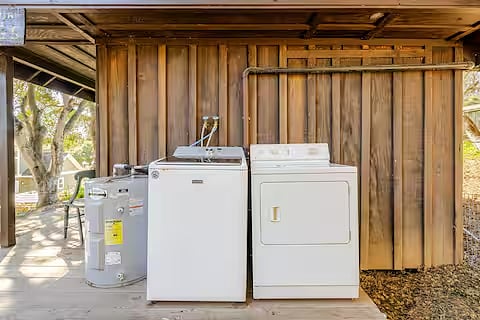 The shared washer and dryer are located on the side deck of the cottage.